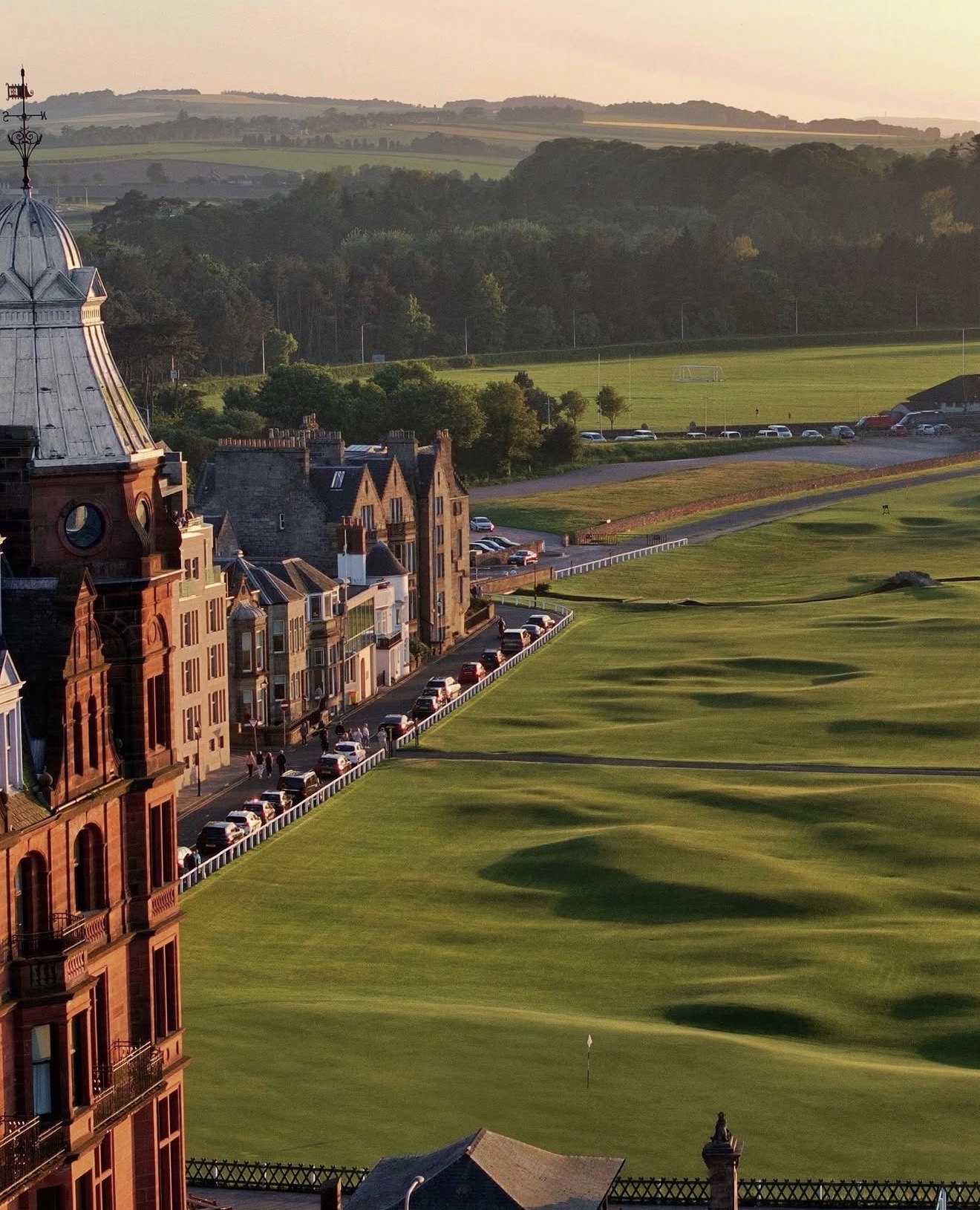 The Hamilton Grand at St Andrews at sunset with the Old Course fairway alongside