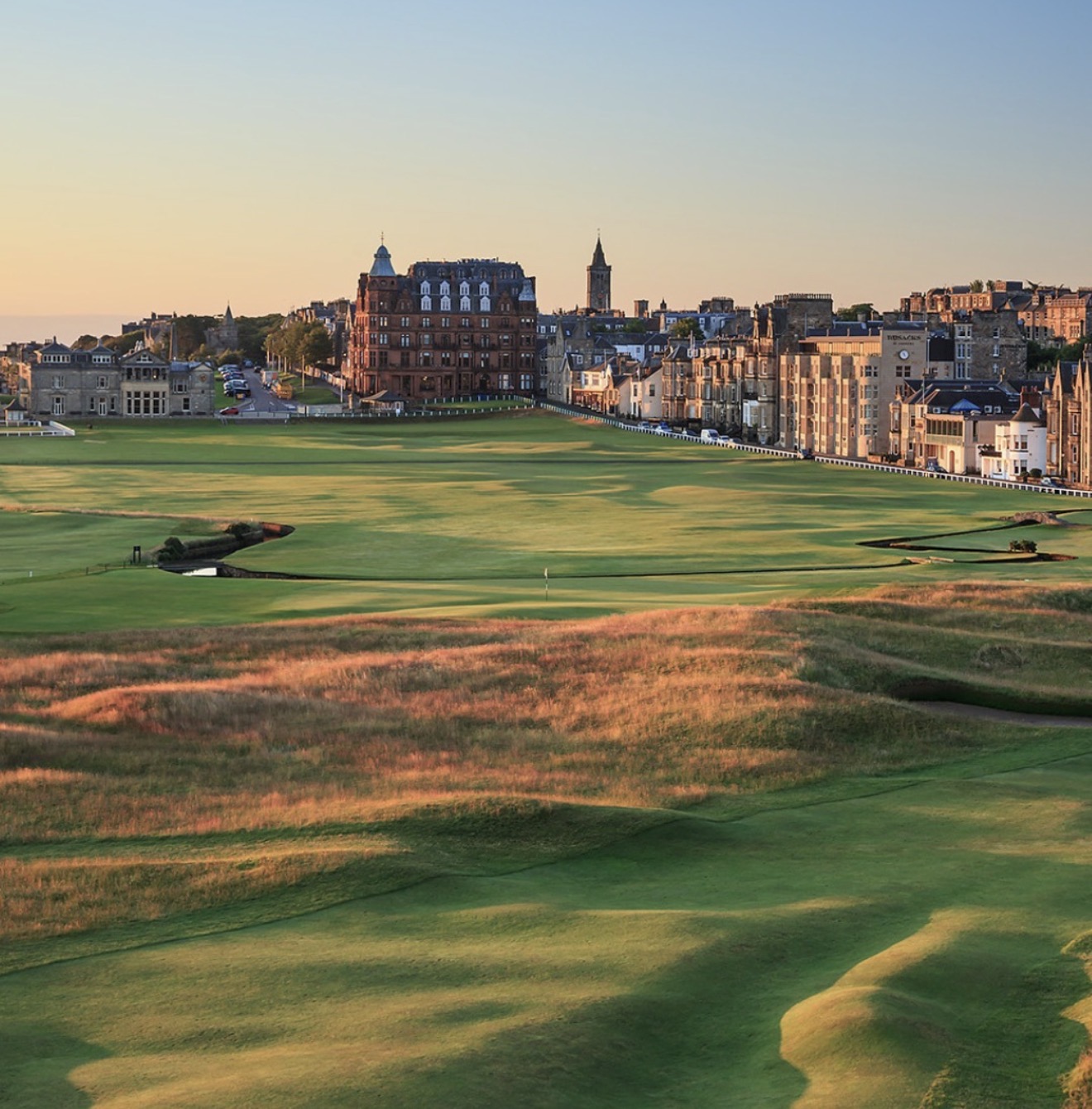 The Old Course at St Andrews at sunset with the Hamilton Grand building overlooking the 18th fairway