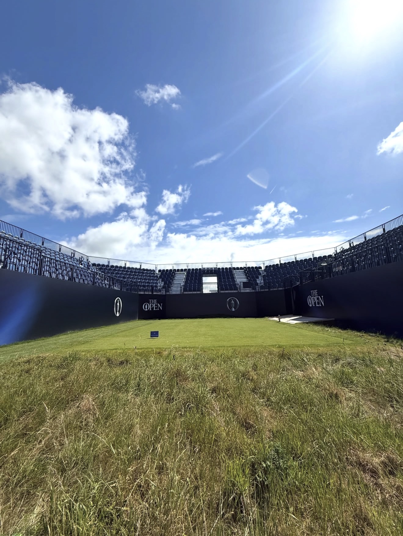 Championship tee flanked by The Open branded grandstand walls with Claret Jug logos