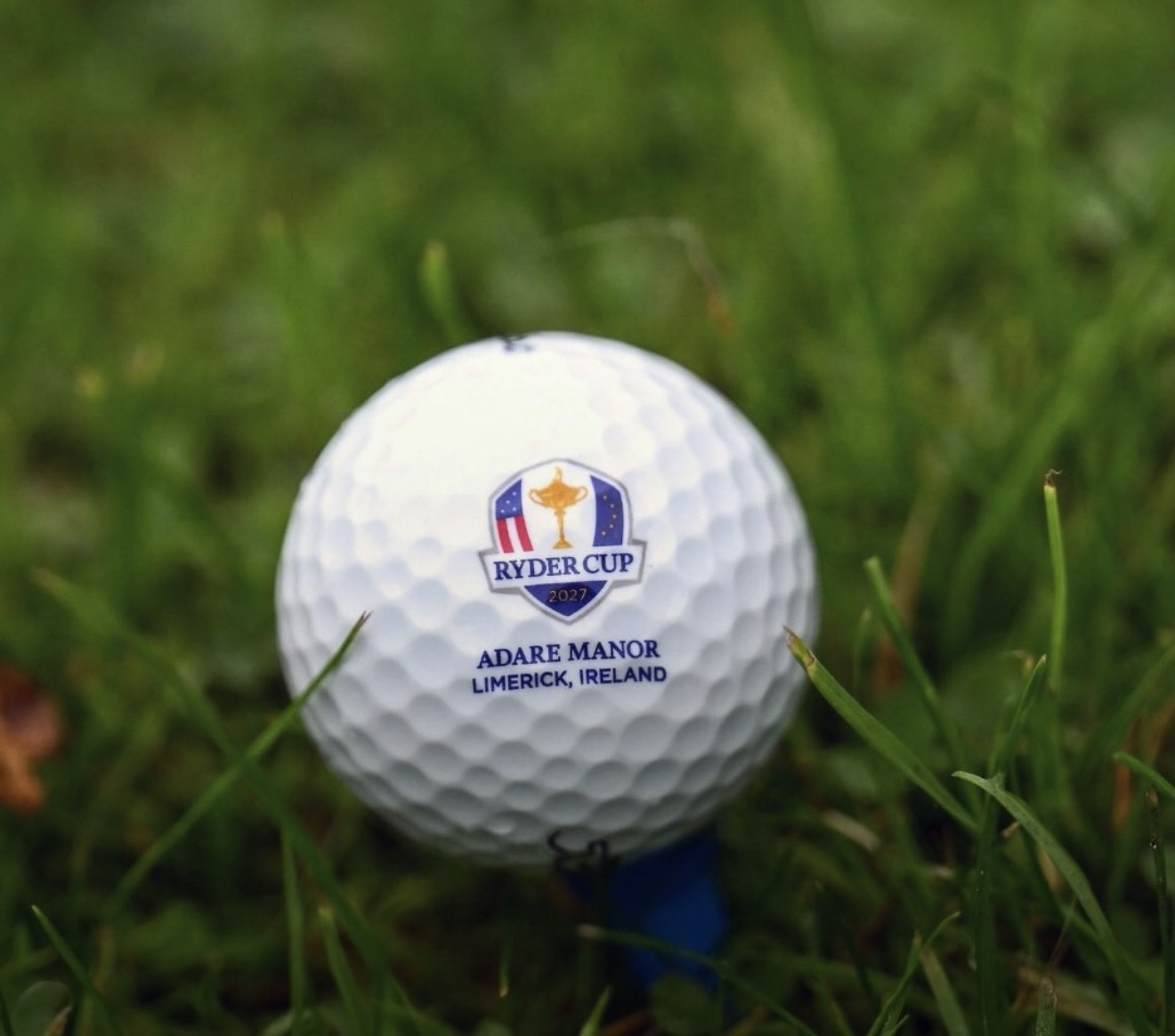 Ryder Cup 2027 golf ball printed Adare Manor Limerick Ireland on a blue tee in grass